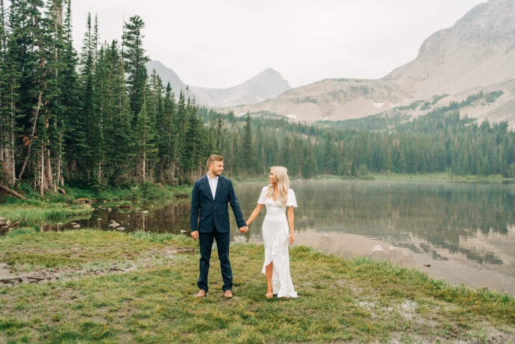 a newly married couple stands in front of Lake Mitchell during their elopement