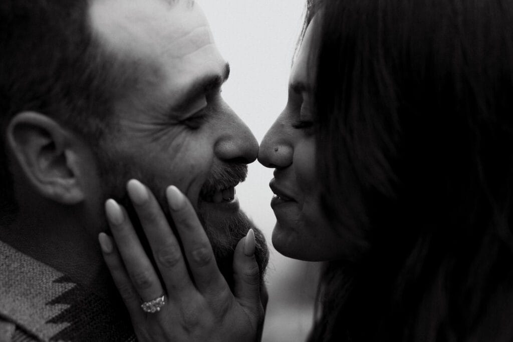cute newly engaged couple giving each other eskimo kisses during their proposal in colorado