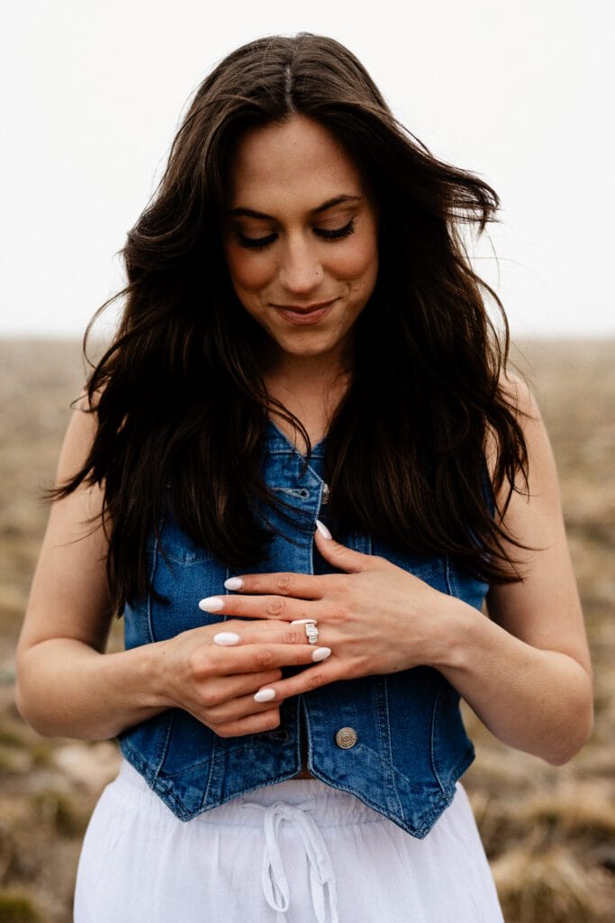 girl trying on her engagement ring after her proposal in colorado