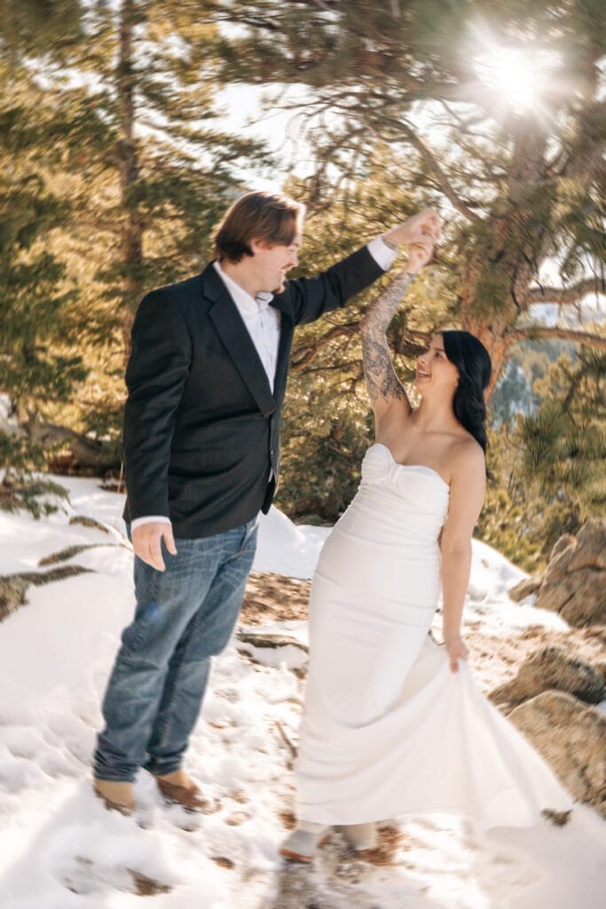 blurry image of groom twirling bride in the forest during their Boulder Elopement