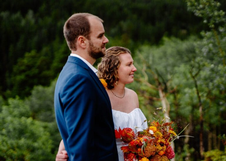 bride and groom listening to their families speak during their eldora mountain elopement in colorado