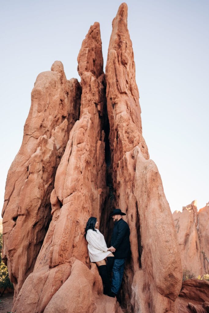 boyfriend and girlfriend holding hands inside a slot canyon during their garden of the gods photoshoot
