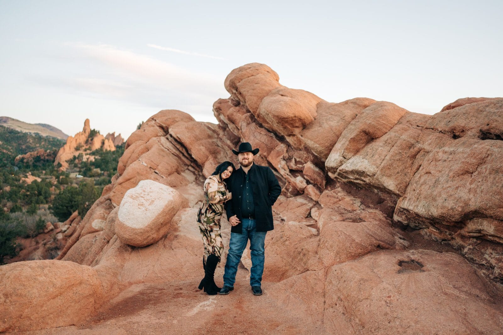 girlfriend resting her head on her boyfriend during their garden of the gods photoshoot with the red rocks in the background