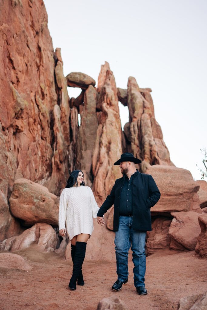 boyfriend and girlfriend holding hands during their garden of the gods proposal photoshoot