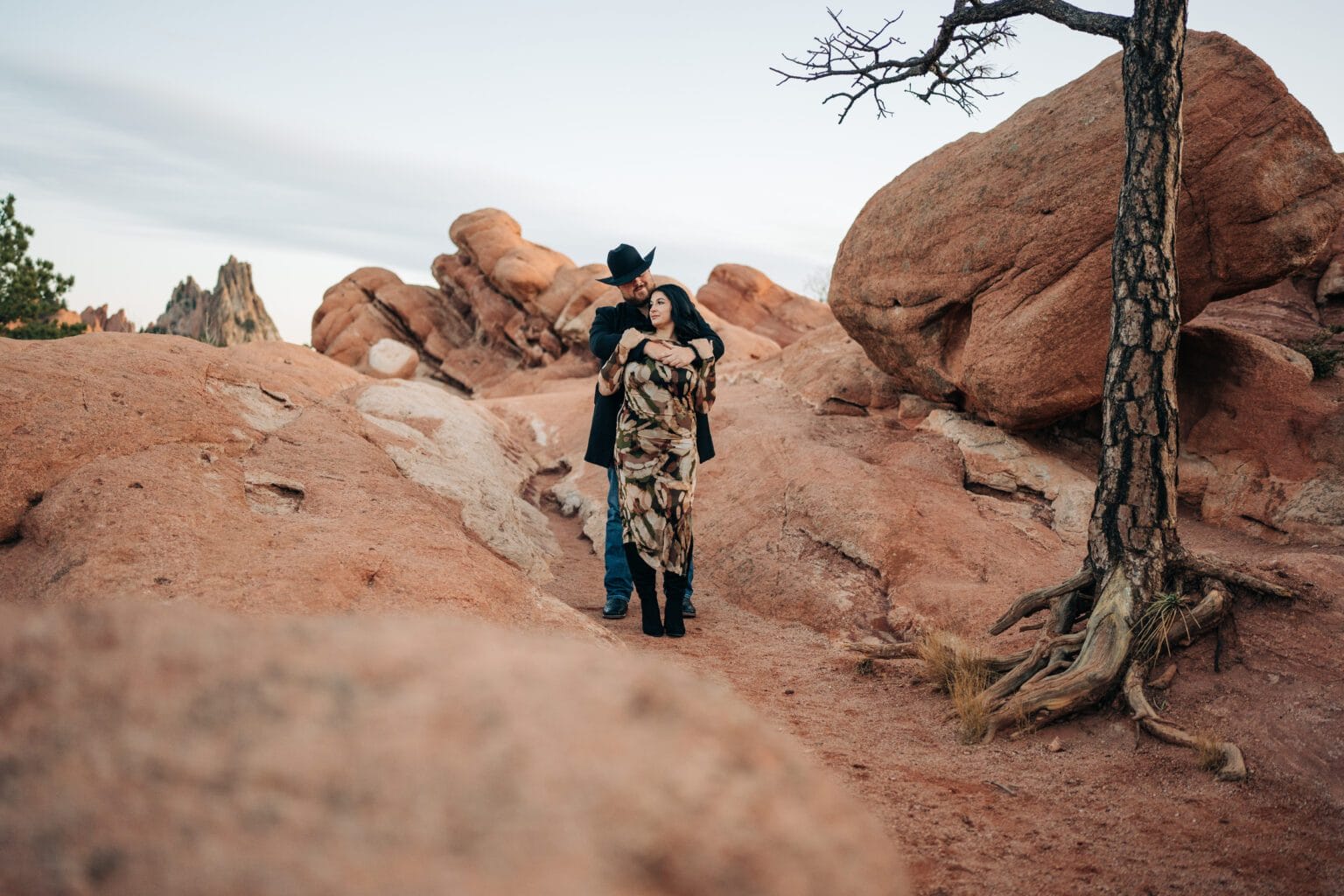 boyfriend hugging his girlfriend from behind during the garden of the gods photoshoot