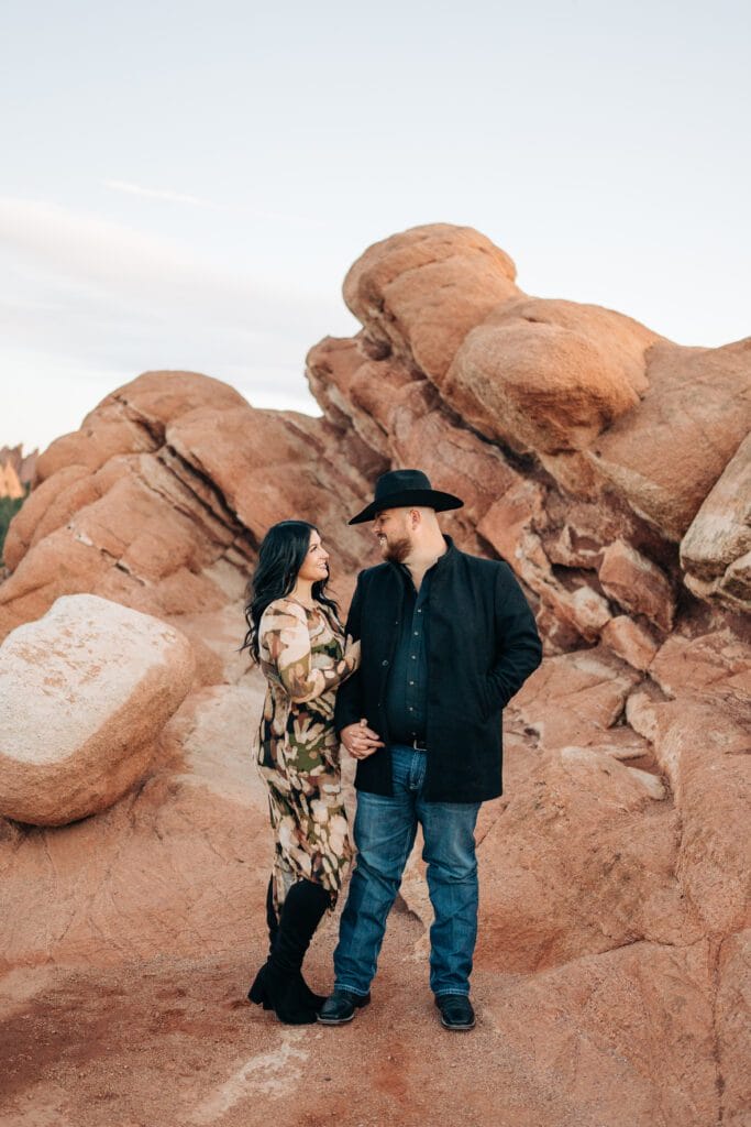 girlfriend holding onto her boyfriends arm during their garden of the gods photoshoot