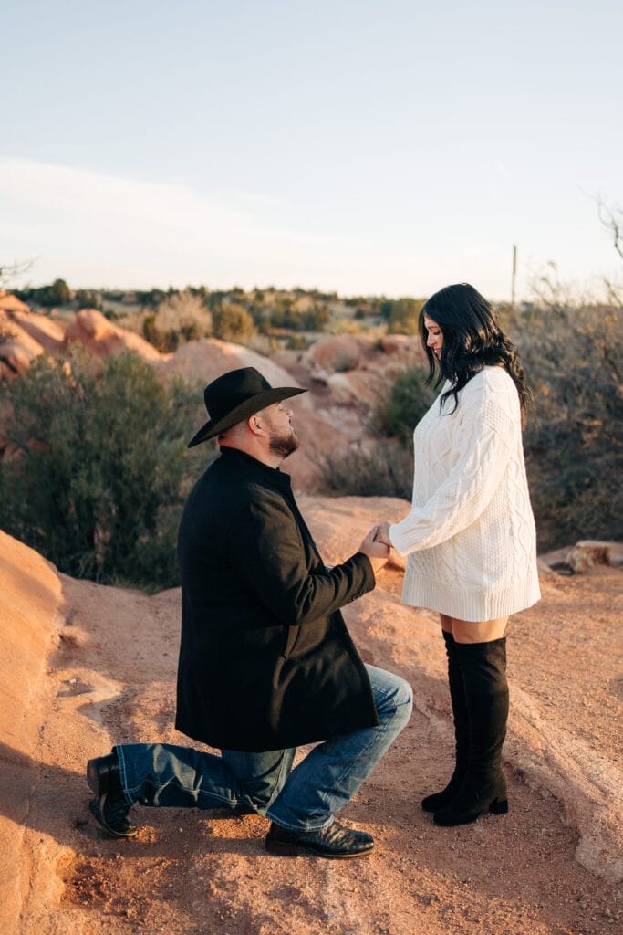 girlfriend looking at her boyfriend while he's proposing to her during their garden of the gods photoshoot