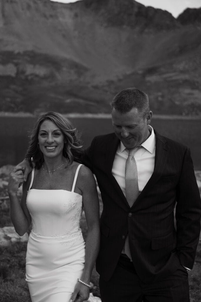 Bride and groom with their hiking gear on as they traverse a hiking trail in the San Juan mountains during their Telluride elopement