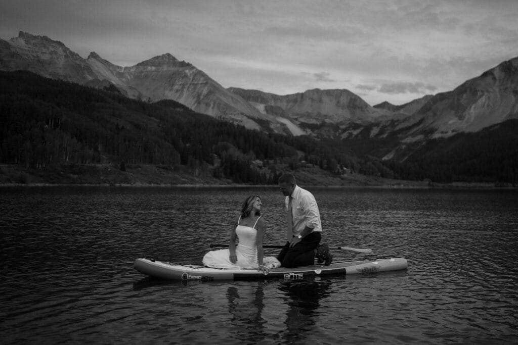 sunset photo of bride and groom paddleboarding during their Telluride elopement