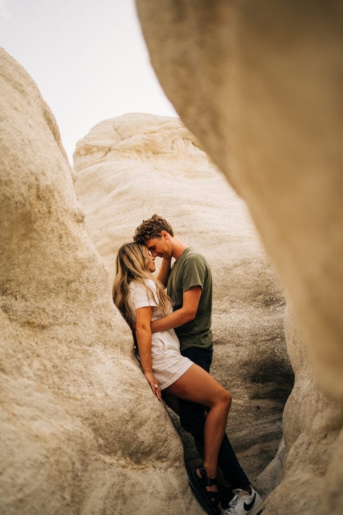 boyfriend leaning against the rocks during their Colorado Paint Mines couples photoshoot