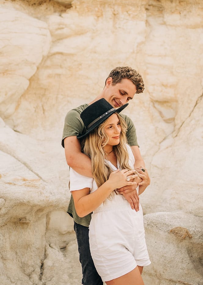 boyfriend hugging girlfriend from behind during their couples photoshoot at the Colorado Paint Mines