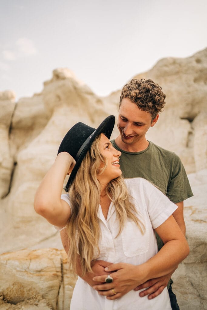 Girlfriend smiling back at boyfriend during their couples photoshoot at the Colorado Paint Mines