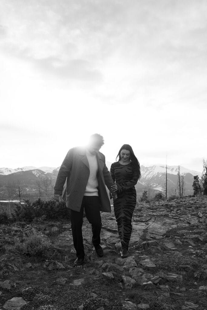 Couple walking on rocky mountain trail at sunset at sapphire Point overlook