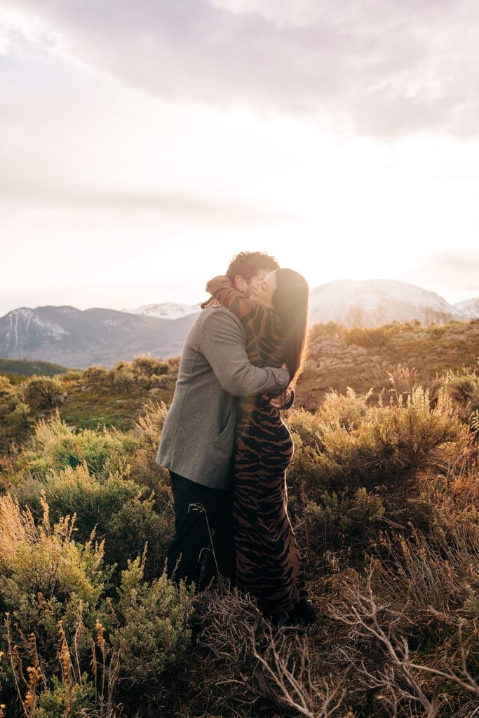 Chelsea and Eric hugging at Sapphire Point Overlook at sunset during their engagement photos