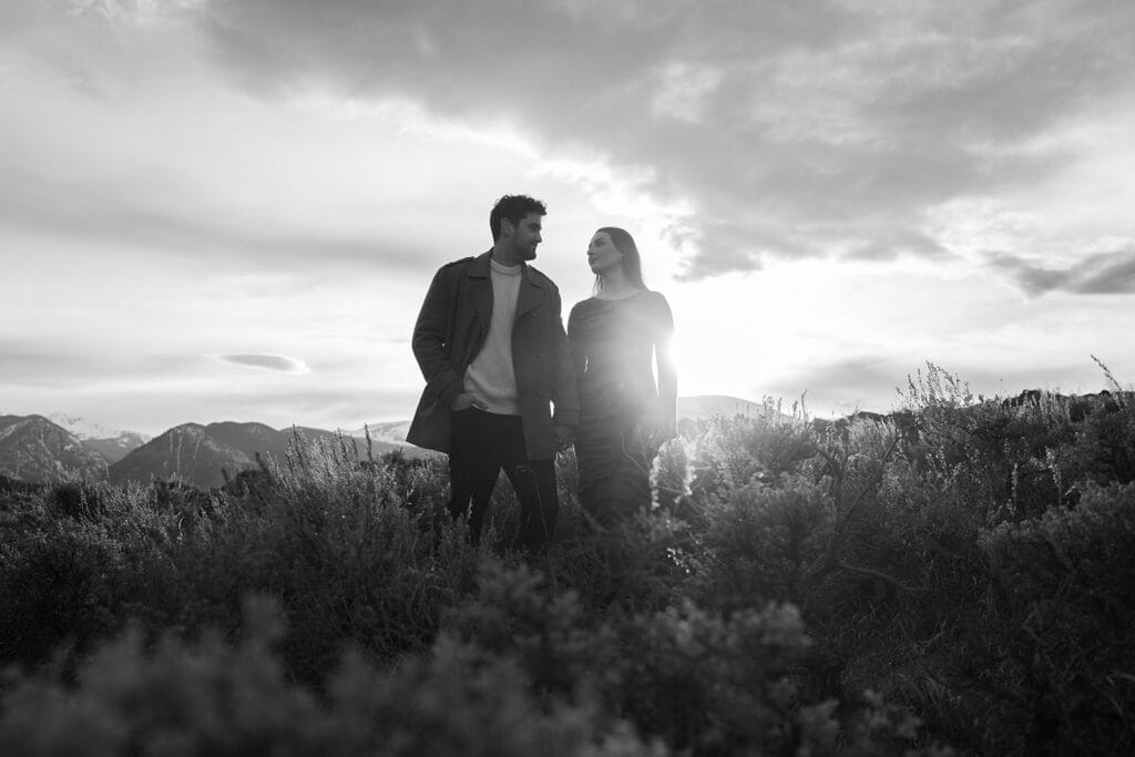 Chelsea and eric holding hands and looking at each other during sunset at Sapphire Point Overlook