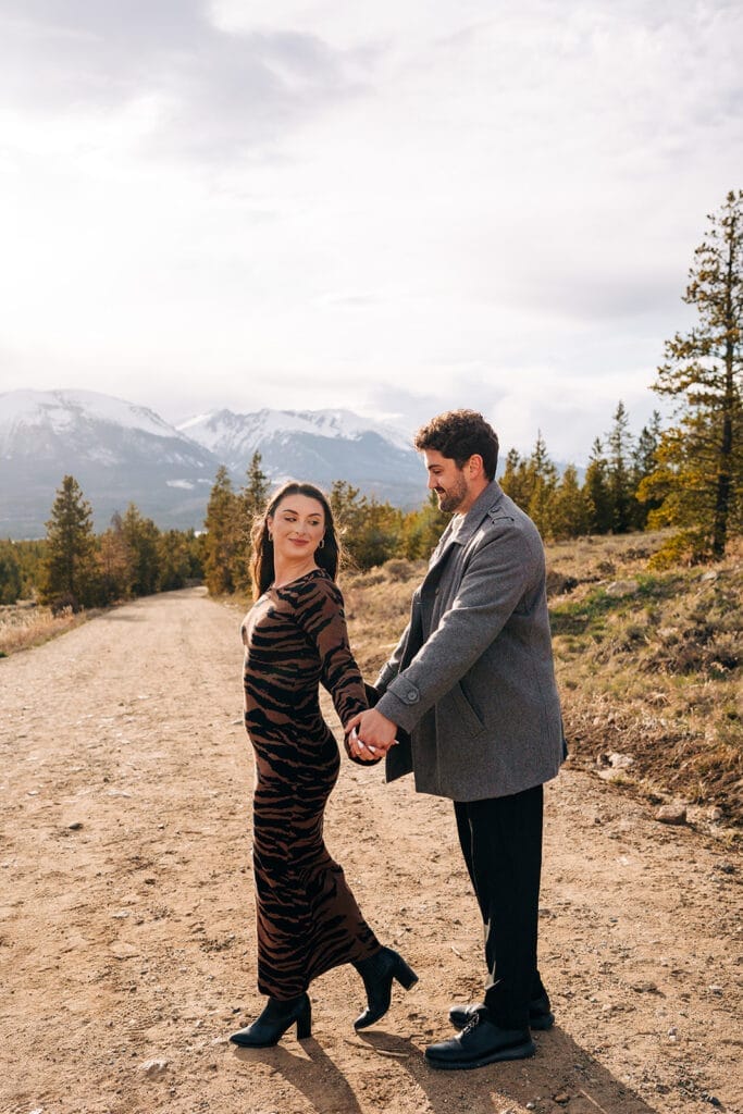 Couple holding hands during engagement photos at sapphire point overlook