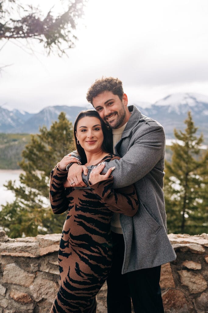 Couple smiling at the camera after he proposed at Sapphire Point Overlook in Breckenridge, CO